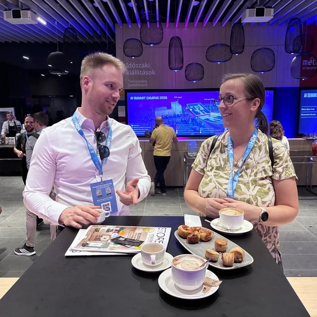 Edina and Norbert discussing a presentation in the break of the AI Summit 2026