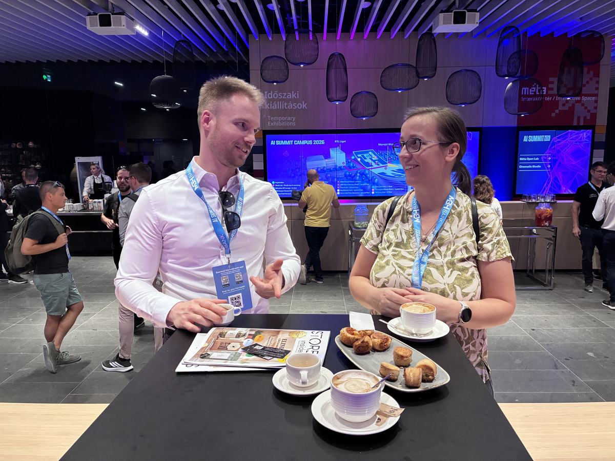 Edina and Norbert discussing a presentation in the break of the AI Summit 2026
